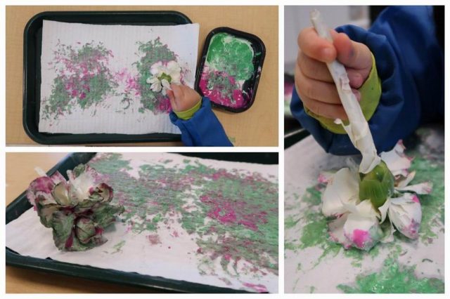 Child painting with a flower
