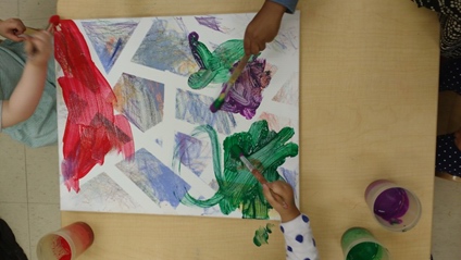 Children under 3 working on oil pastel scribble art 