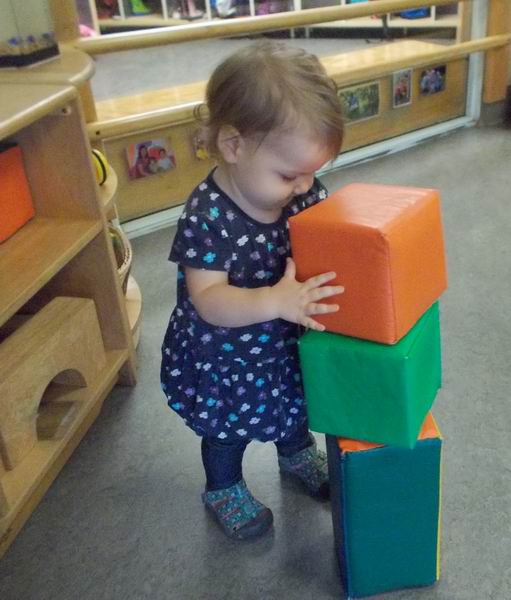 Child under 2 building with blocks