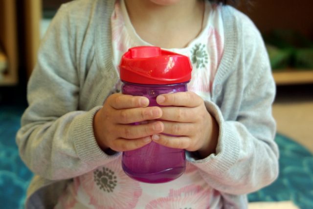 Casa child holding a water bottle