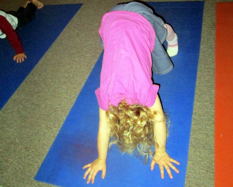 Child doing a 'downward dog' yoga pose