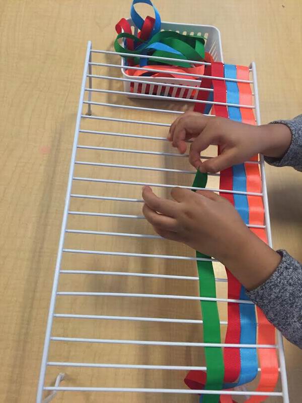 Child weaving ribbon