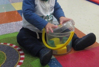 child under 2 opening a container