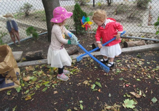 Children raking leaves