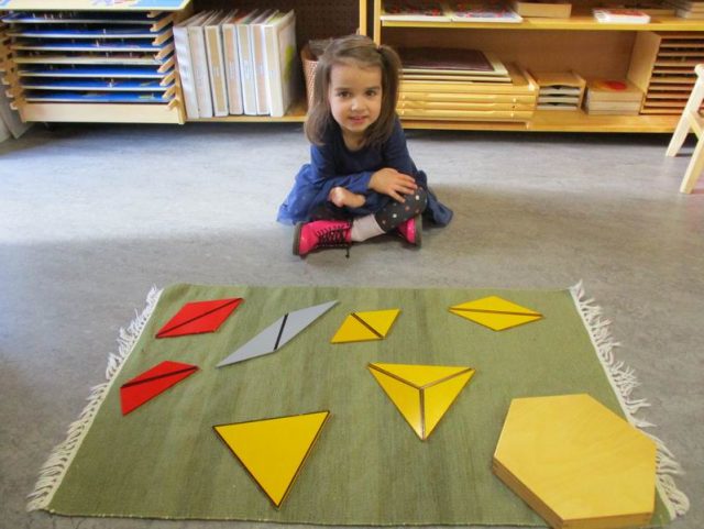 Child observing completed constructive triangles