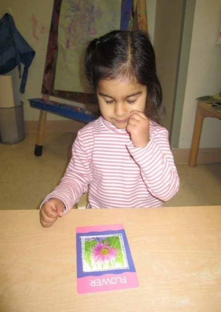 child under 3 making the sign language for flower