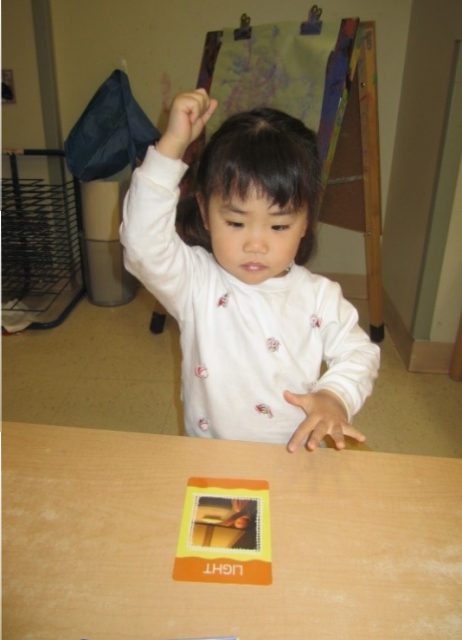 child under 3 making the sign language for light