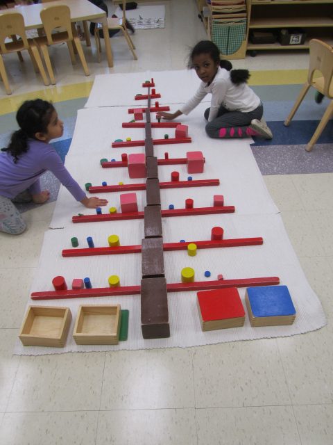 Casa children building holiday tree with Sensorial materials