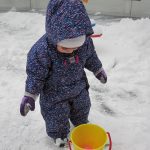 Child under 2 playing in the snow