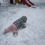 Child under 2 playing in the snow
