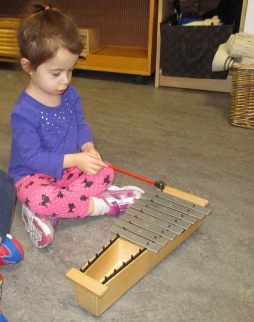 Child playing a metallophone