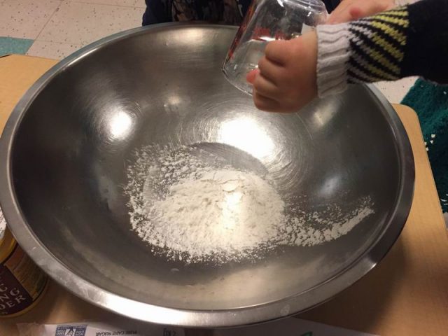 Child pouring in ingredients