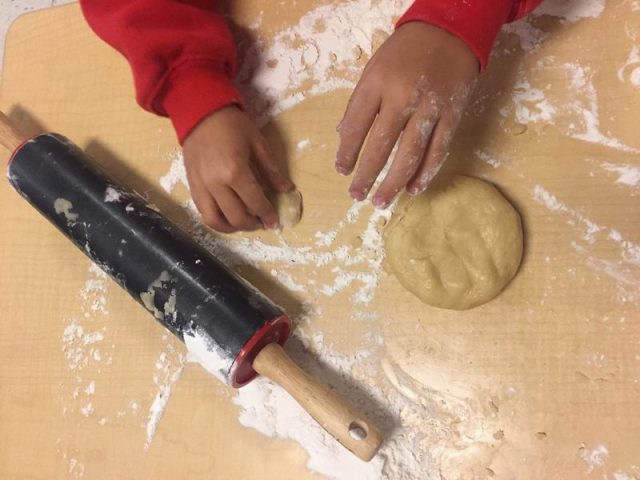 Child kneading dough