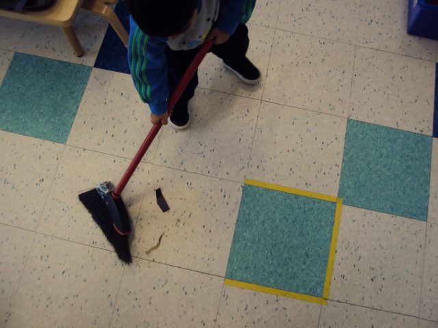 Child sweeping floor