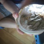 Casa child holding a shell with sage