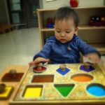 Child under 2 working on a puzzle