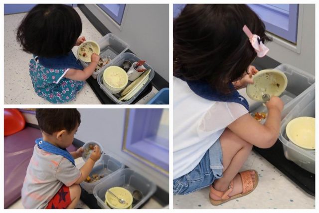 Children scraping their food dishes