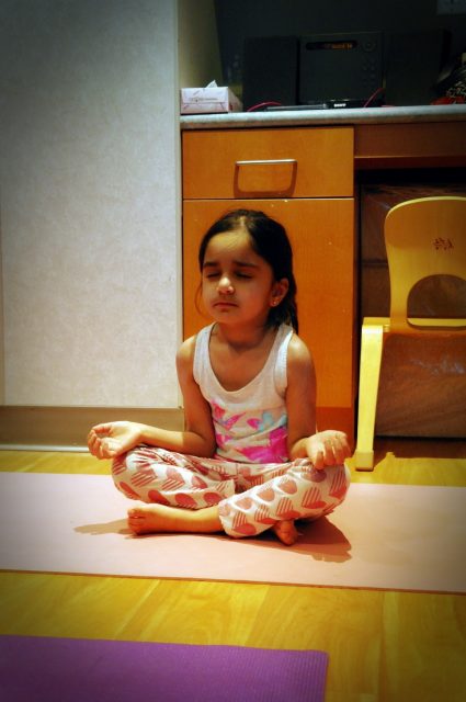 Casa child practicing yoga