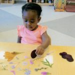 Child under 2 decorating a sun catcher