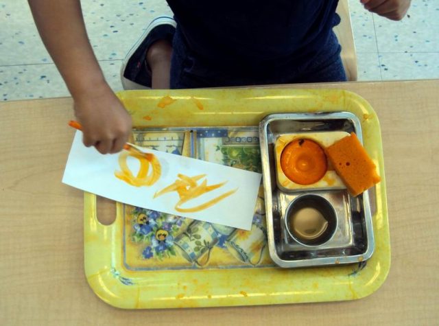 Child painting with water colours