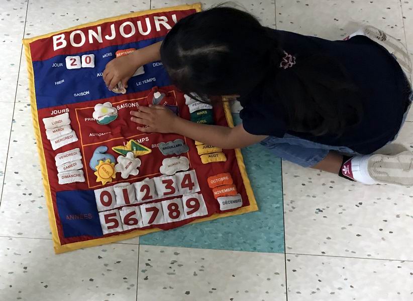 Child working with French materials