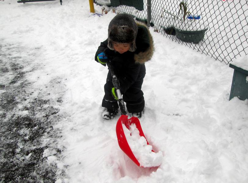 Child shoveling snow