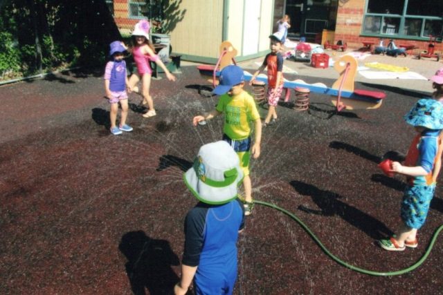 Children playing in the sprinkler