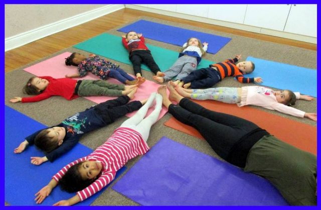 Children engaging in a flower yoga pose