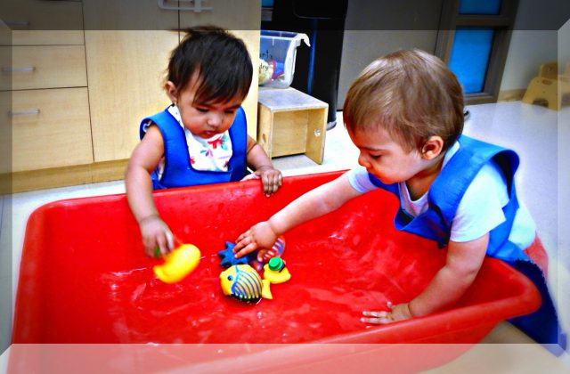 Children under 2 engaged in water play