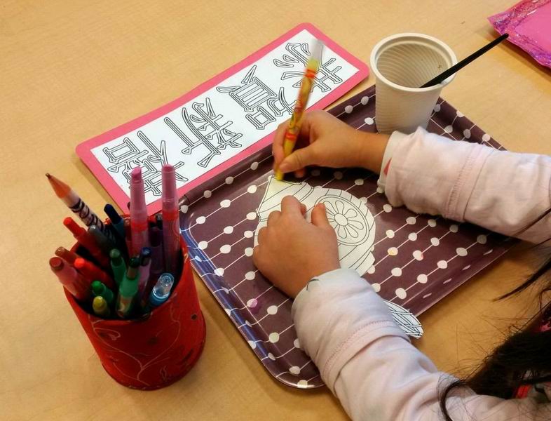 A child colouring a lantern