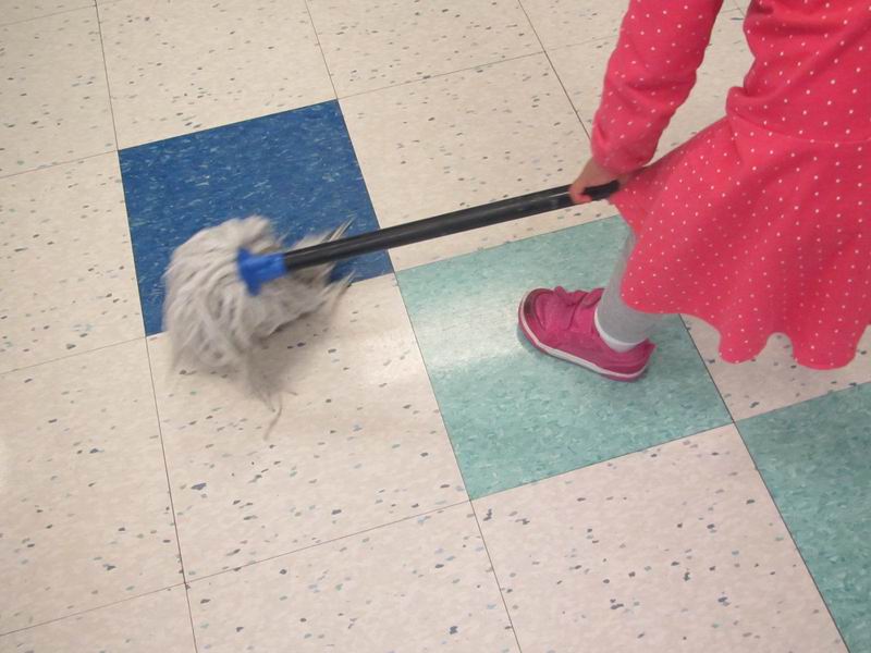 A child mopping