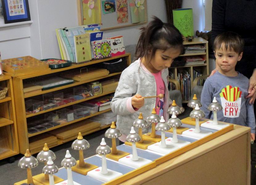 Child playing Montessori Bells