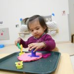 Child under 2 exploring playdough