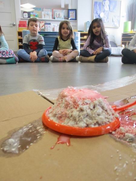 Children watching a volcano science experiment