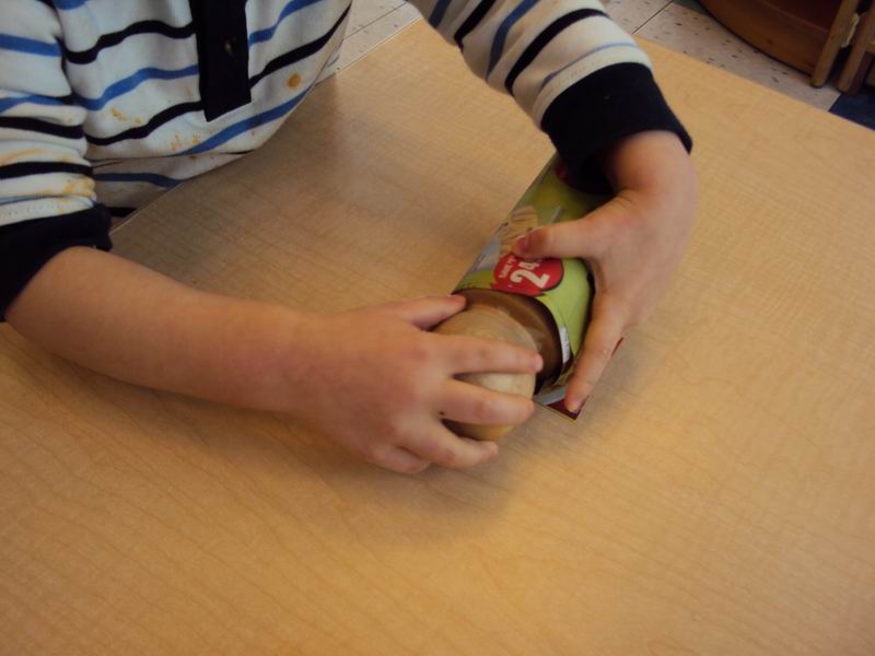 A child making a biodegradable planter