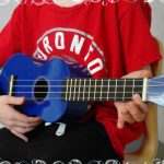 Casa child playing the ukulele
