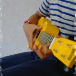 Casa child playing the ukulele