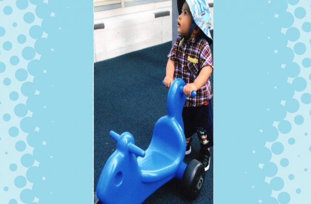 Child under 2 pushing blue scooter