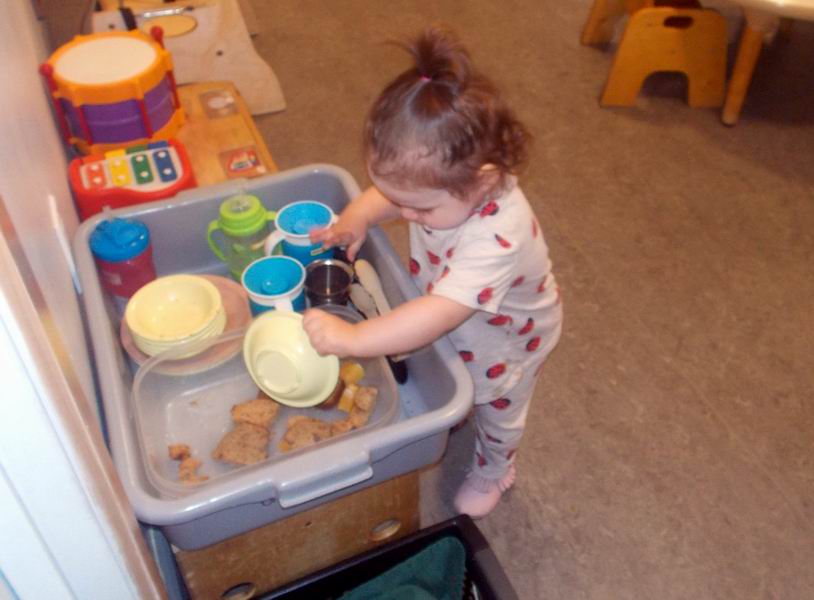 Child under 2 scraping a dish