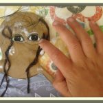 Casa child gluing hair to a cultural doll