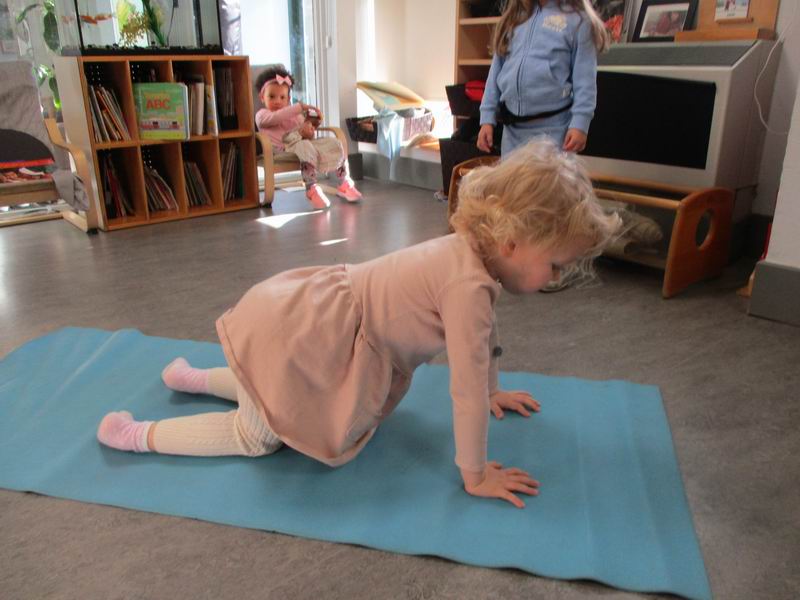 Child practicing the Table Top yoga pose