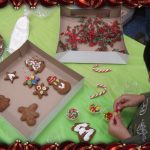 Casa child decorating gingerbread cookies