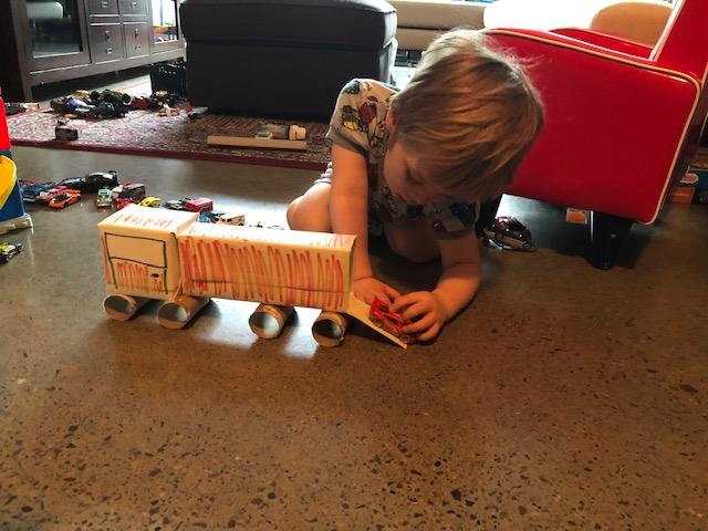 Christina's son using the recycled art truck he made