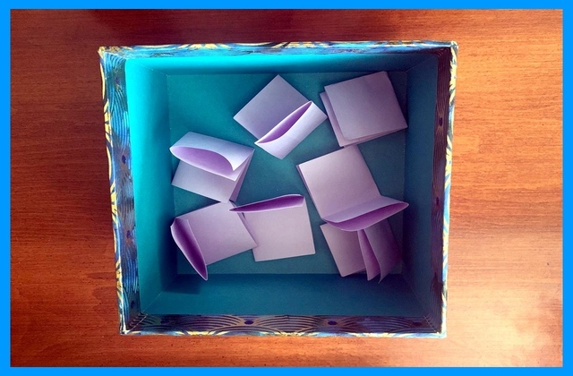 Folded papers in Whisper Box