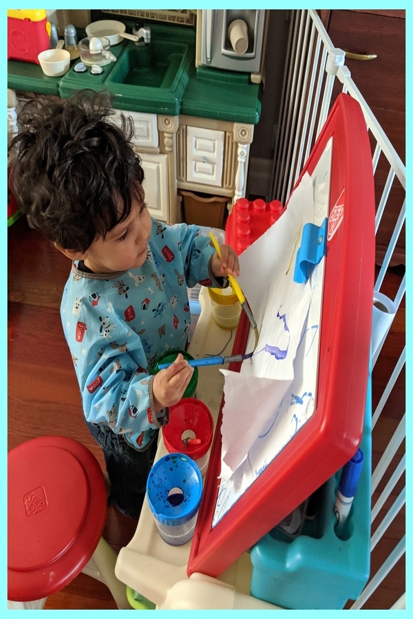 Gianluca painting on the easel