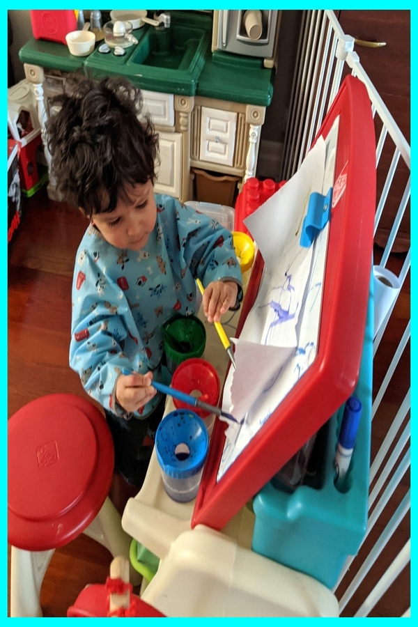 Gianluca painting on the easel