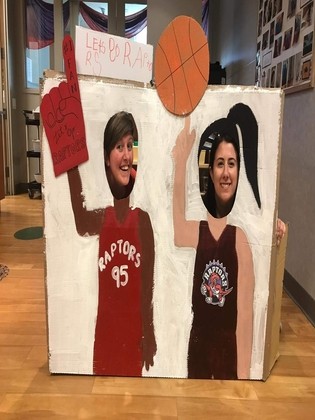 Maria and Brittany posing behind Raptors cut-out