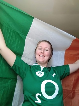 Maria holding an Irish flag