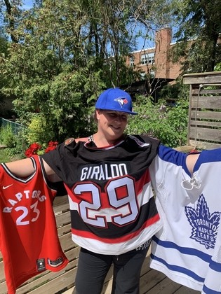 Leah holding Toronto Sports jerseys