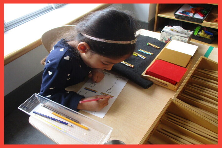 Child doing a making 10 colouring sheet beside the 10's she made.